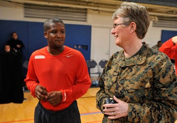 Cmdr. Laura Bender, chaplain of the Marines' Wounded Warrior Regiment, talks to members of the regiment's team in the Pentagon gym. A UMNS photo by Jay Mallin.