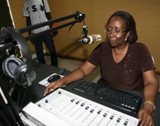  Acquah, director of the new 101.6 FM station, demonstrates the production studio equipment.