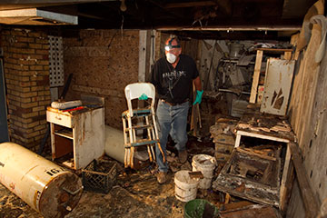 Volunteer Tim Guth helps clean up flood damage at the home of Edward Ortiz in Minot, N.D., in August 2011. He is part of a Volunteers in Mission Team from the Indiana Annual (regional) Conference of The United Methodist Church.  A UMNS file photo by Mike DuBose.