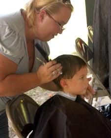 A little boy receives a haircut as part of back-to-school activities at Wesley Memorial United Methodist Church in Pace, Fla. A 2002 file photo courtesy of Wesley Memorial United Methodist Church.