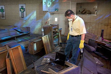 The Rev. Darryl Tate views the ruined sanctuary of St. Luke's United Methodist Church in New Orleans in September 2005.