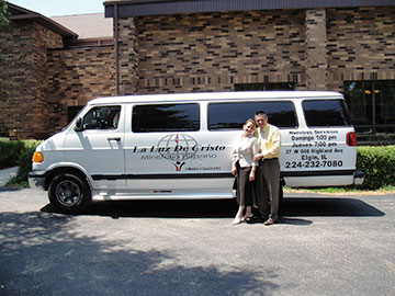 The Riveras pose with the church van.