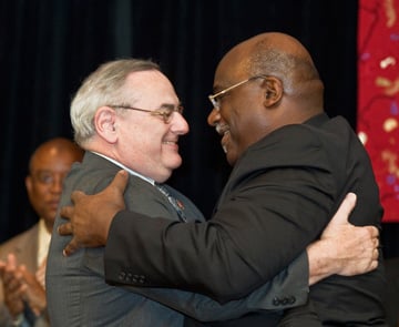 Bishops Goodpaster and Palmer embrace following the passing of the gavel.  A UMNS photo by James D. DeCamp.