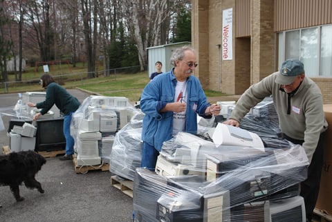 The Rev. Charlie West (center), pastor of Grace United Methodist Church in Marquette, Mich., collects electronic discards during the 2006 Earth Keeper Clean Sweep. A UMNS file photo by Greg Peterson.