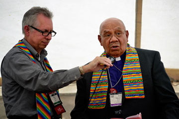 Retired Bishop Melvin G. Talbert (right) joined 14 other United Methodist bishops at a gathering on May 4 outside the 2012 United Methodist General Conference in Tampa, Fla. The gathering was organized by groups that want to see the church change its stance on homosexuality. A UMNS photo by Paul Jeffrey.