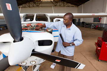 Missionary pilot and mechanic Gaston Ntambo readies the Wings of the Morning plane for its next flight. A UMNS photo by Mike DuBose.