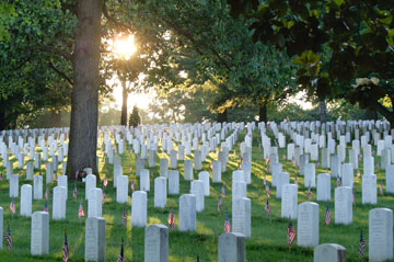 At Arlington (Va.) National Cemetery, flags decorate the tombs of those who died in the service of their country. Photo courtesy of Arlington National Cemetery.