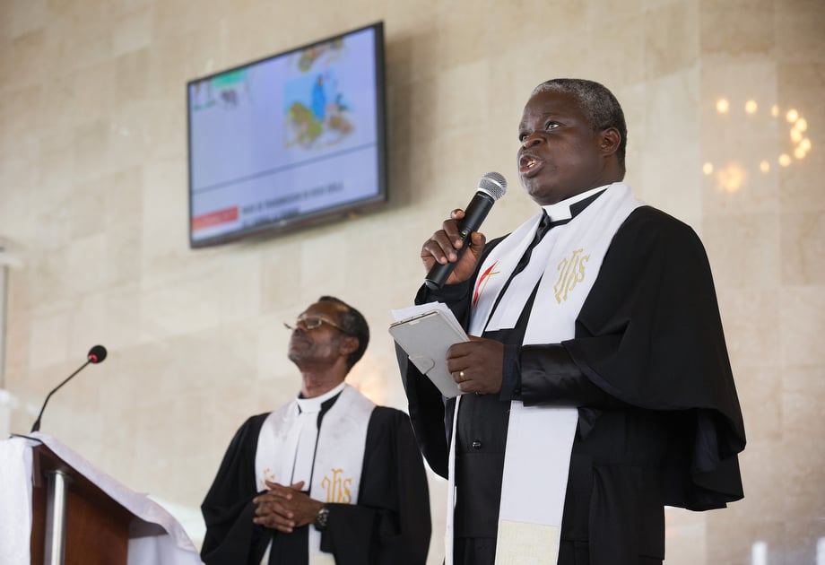 The Rev. Marcel Sachou (right) uses a video presentation to describe ways to help parishioners prevent Ebola at Temple Bethel United Methodist Church in Abobo-Baoule, outside Adidjan. At left is the Rev. Esaïe M’Ye Gnamien, the district superintendent. 