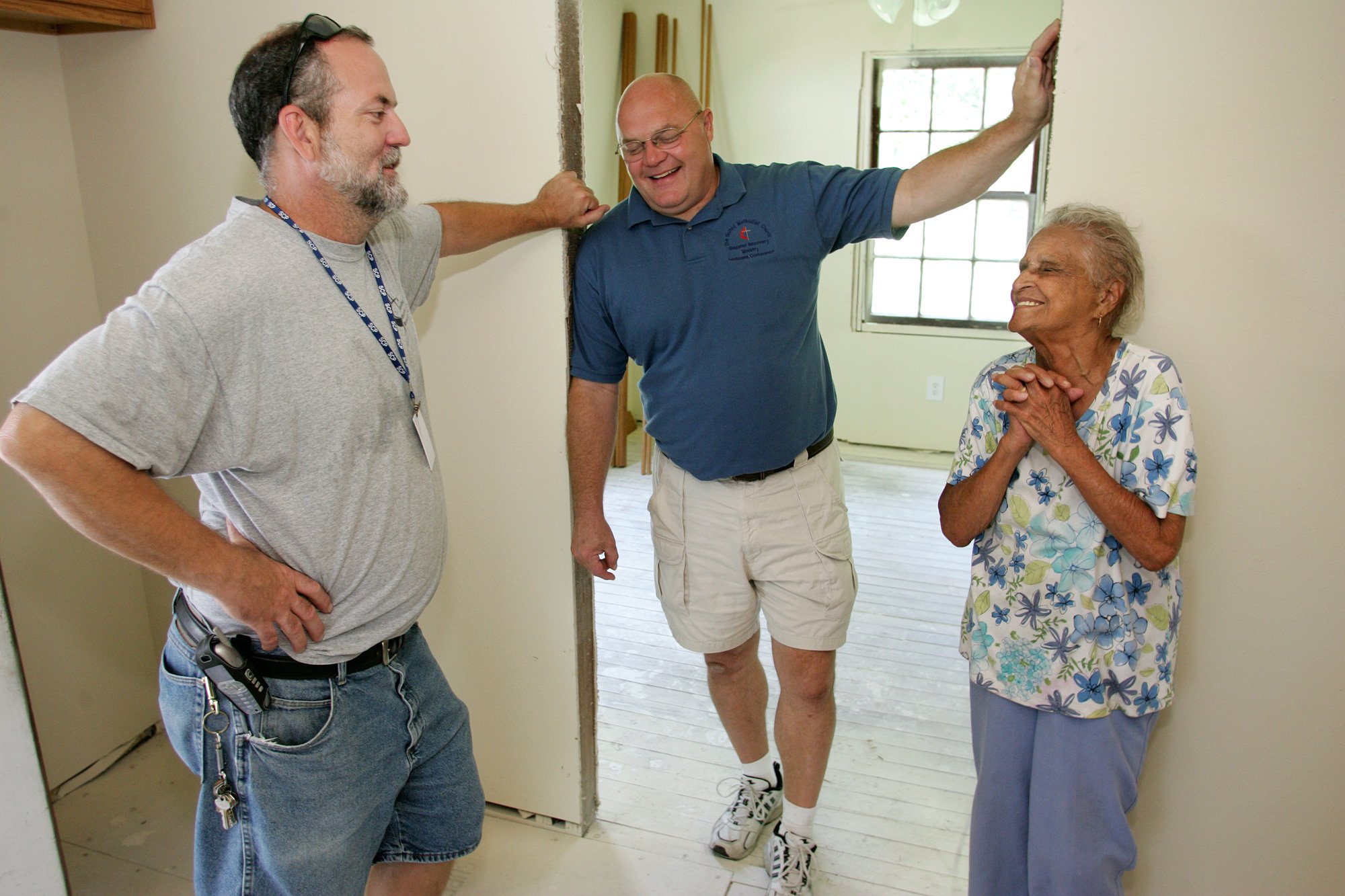 Ken Ward (left) and Dale Kimball say people like Leona Cousins, 95, are the reason they work long hours with the United Methodist Slidell (La.) Disaster Recovery Station. A UMNS photo by Mike DuBose.