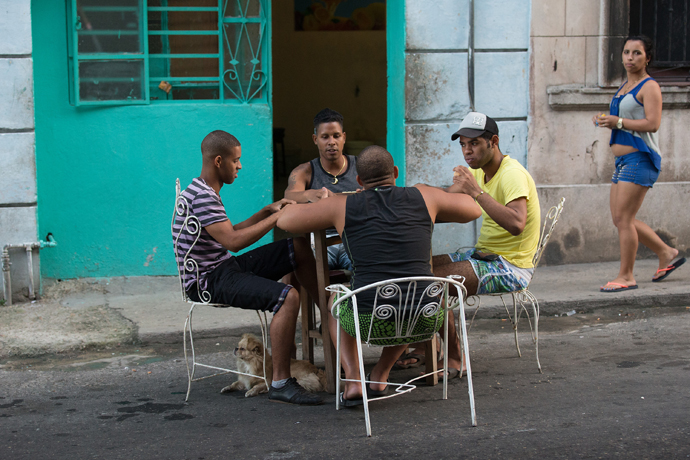 Friends play dominoes at a table pulled into the street in Havana. “Life here is very sociable,” says Rigoberto Figueroa, — a member of Marianao Methodist Church and vice rector of the Havana seminary. Photo by Mike DuBose, UMNS.