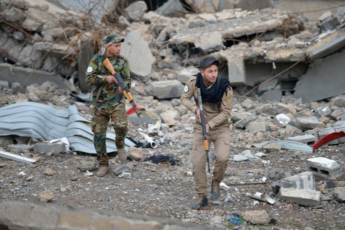 Members of the Nineveh Plain Protection Units, a Christian militia, patrol the town of Qaraqosh, a Christian community that was occupied by the Islamic State in 2014 and liberated by the Iraqi army in late 2016. Residents have yet to return, citing continued insecurity. Photo © Paul Jeffrey.