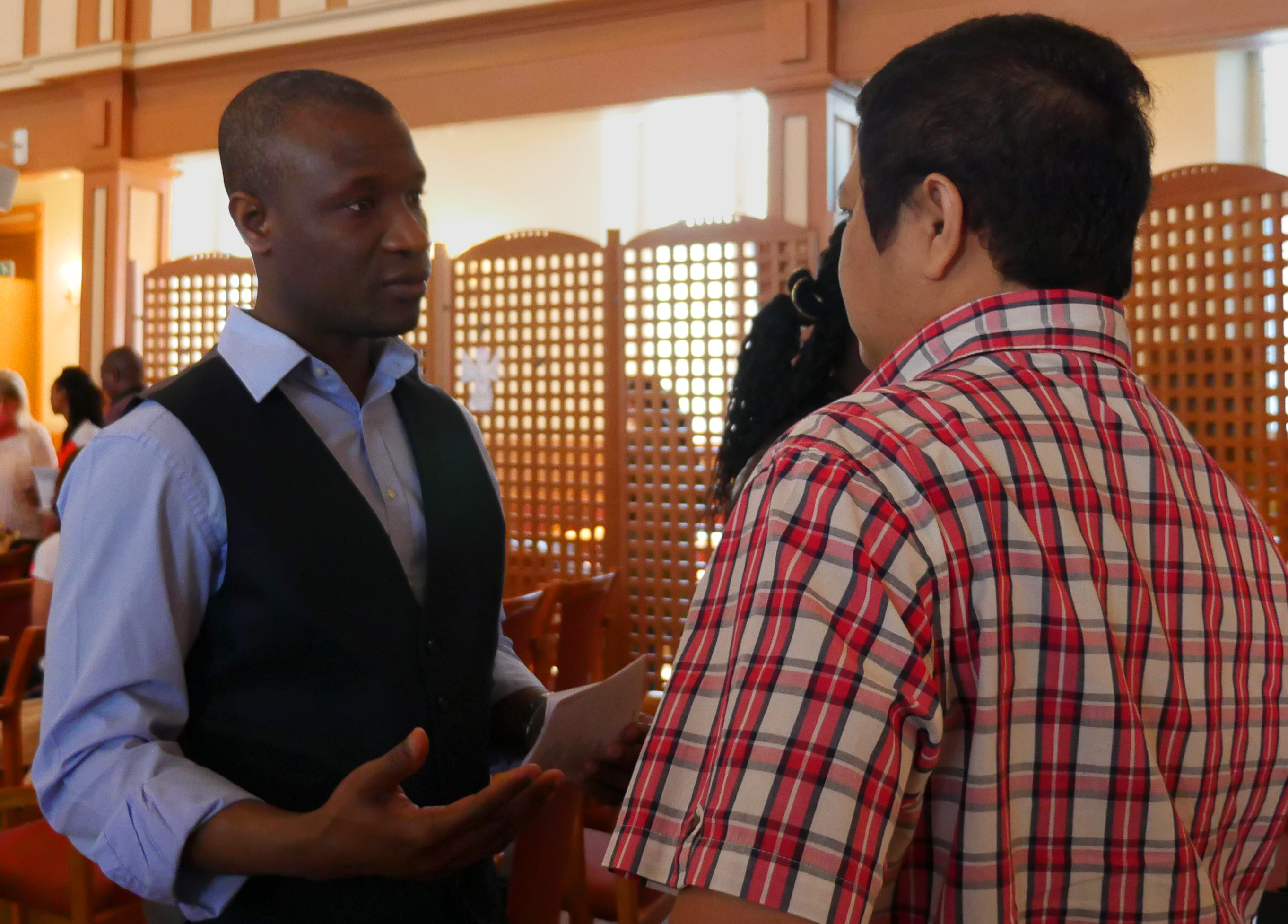 Victor Sekyere, one of the earliest members of International Methodist Church Oslo, talks to a fellow parishioner after worship. Sekyere, originally from Ghana, will be commissioned in June as a provisional elder in the Norway Annual Conference. Photo by Heather Hahn, UMNS