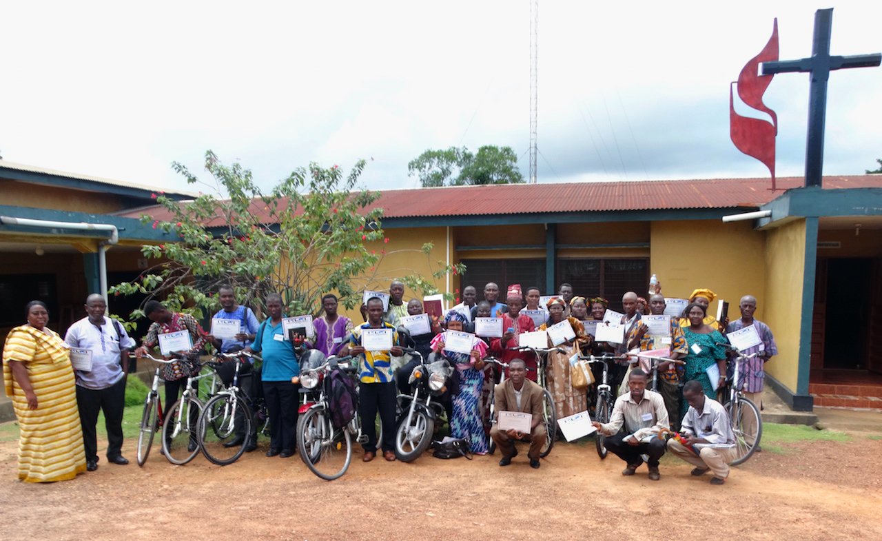 Clergy and lay leaders display their certificates and bikes after a Bikes and Bibles training session at the Child Rescue Center in Bo, southern Sierra Leone. Members of the Anglican Church, United Brethren in Christ and United Methodist Church took part in the training. Photo by Phileas Jusu, UMNS.