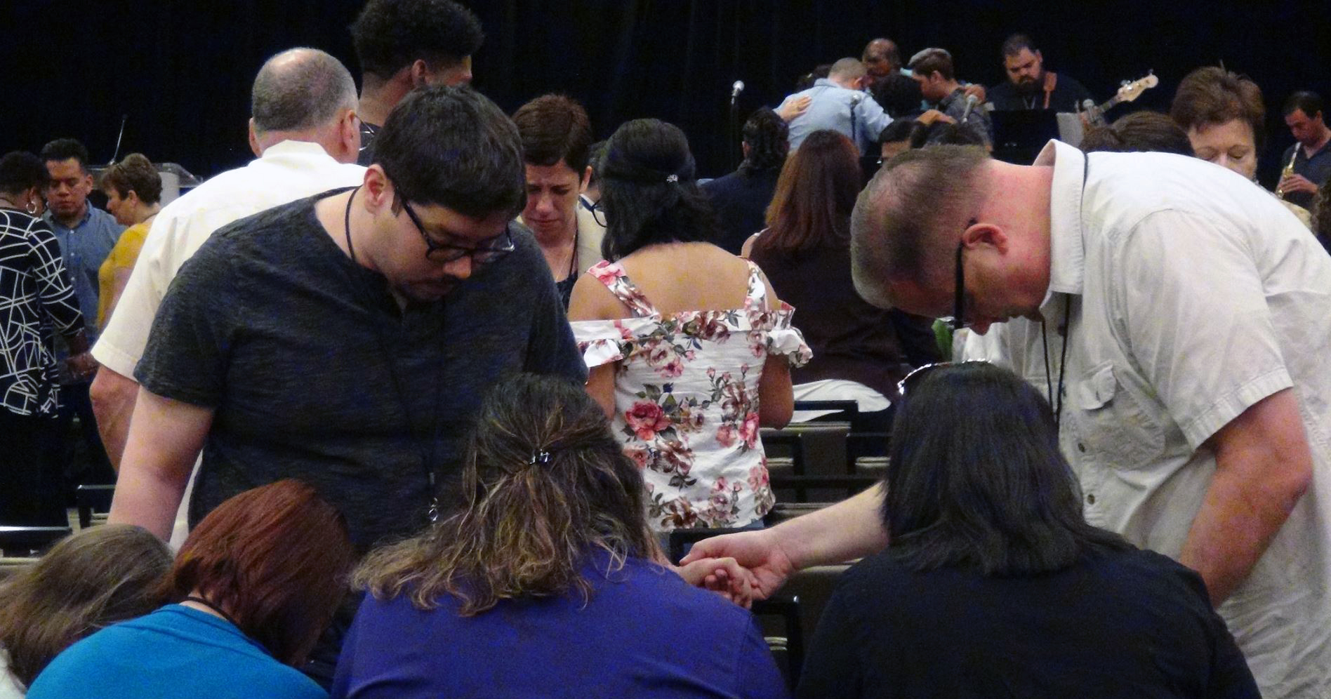 Ivan Gonzalez (l) and the Rev. Alan Felton lead a small group in prayer during the Aug. 10-13 MARCHA assembly in Dallas. MARCHA, the Hispanic/Latino caucus of The United Methodist Church, met for worship, plenary addresses and workshops. The group also observed the 25th anniversary of the National Plan for Hispanic/Latino Ministry. Photo by Michelle Maldonado.