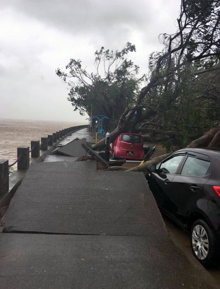 Cars sink below the level of an upended roadway in Macau, China. Deaths were reported in Macau and Hong Kong, both now reeling from the aftermath of the winds and floods. Photo courtesy of Macau Dangerous Driving. 