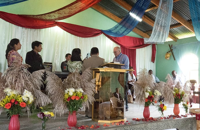 United Methodist Bishop Mike McKee, North Texas conference, accepts gifts from Evangelica Nacional Metodista Primitiva de Guatemala church leaders during a worship service at Iglesia Nacional Methodista Primitiva Fuente De Vida.