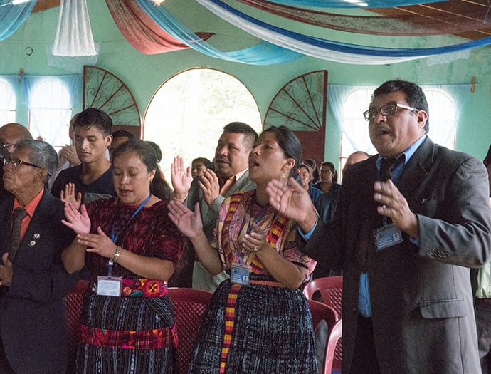 Members of Iglesia Nacional Methodista Primitiva Fuente De Vida and local pastors from the area sing during worship service.