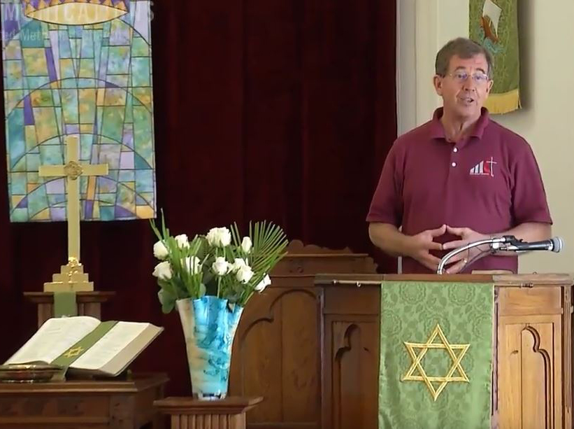 Bishop Scott Jones, the episcopal leader of the Texas Conference, speaks to those gathered for a Sunday worship service after Hurricane Harvey. Video image by Andrew Jensen, United Methodist Communications. 