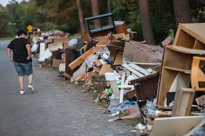 Sandy McCall looks through her furniture and flooded possessions on the street outside her home in Orange, Texas. Photo by Kathleen Barry, UMNS.