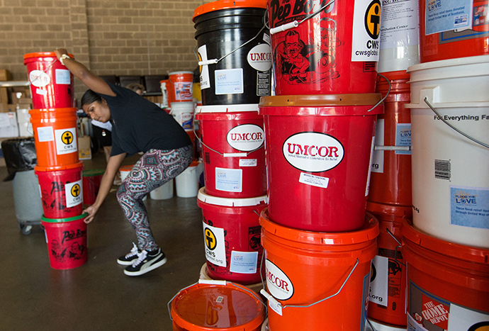 Edna Rajan stacks flood buckets from the United Methodist Committee on Relief at a United Way warehouse in Lafayette, La. Photo by Mike DuBose, UMNS