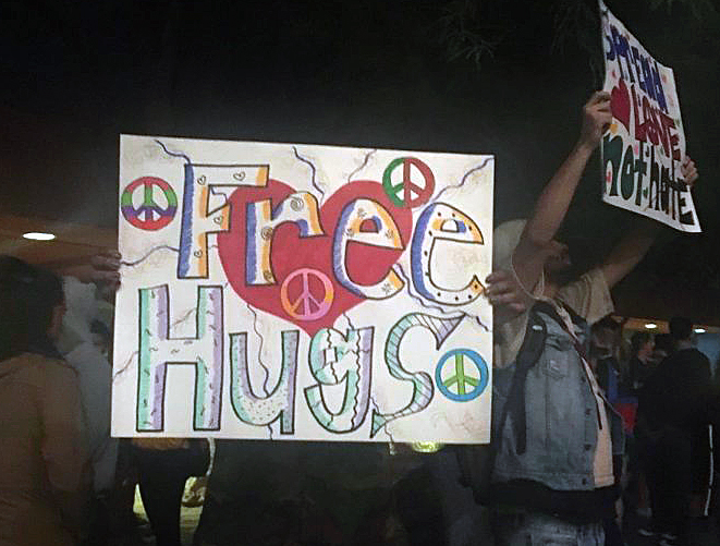 Students hold signs of support at a ministry booth on the campus of University of Nevada, Las Vegas, in response to the Oct. 1 shooting massacre. The site of the mass shooting was close to campus dormitories and students heard sirens of emergency response vehicles through the night. The student ministry offered a safe listening space as care for fellow students. Photo by Susan Holden, courtesy of Desert Southwest Conference.