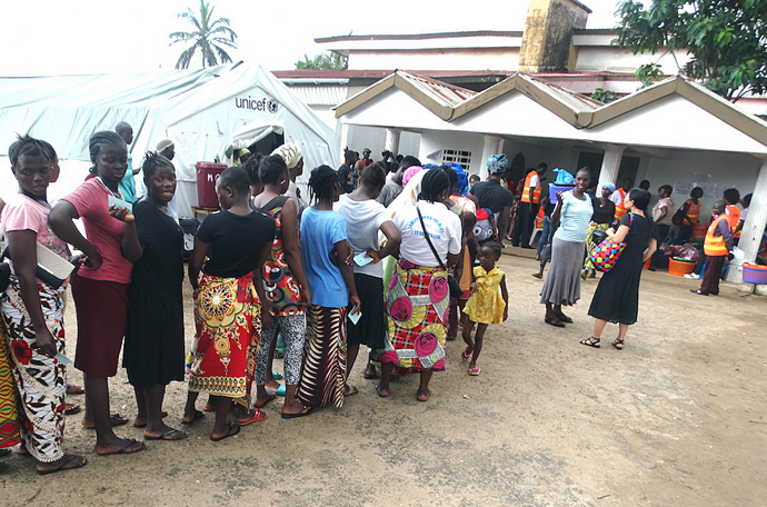 In a photo from September, 2017, survivors of a deadly mudslide on Aug. 14 near Freetown, Sierra Leone, line up at Old School Camp to receive relief items from the Sierra Leone Annual Conference disaster response team. The team distributed good including items specifically for women and children, along with 200 bags of rice — Sierra Leone's staple food. Photo by Phileas Jusu, UMNS.