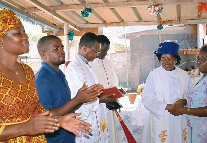 Praise and worship precede baptism at the Female Correctional Center in Freetown, Sierra Leone, facilitated by United Methodist regional missionaries. Photo by Phileas Jusu, UMNS.