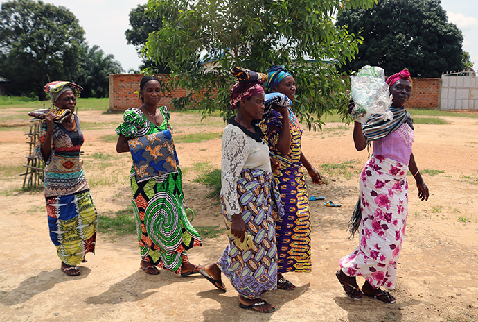 Widows carry supplies received from The United Methodist Church in Kindu, the Democratic Republic of Congo. The church, with assistance from partners in Switzerland and France, secretly distributed food and other support to people displaced by rebel violence. The church team also brought some widows and orphans into safer areas. Photo by Judith Osongo Yanga, UMNS.