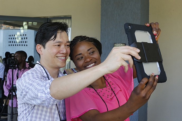 Danny Mai poses for a photo for Irene Kashala Tsheleka from the Democratic Republic of Congo during a training for communicators from the Congo Central Conference held Nov. 13-18, 2017, in Ndola, Zambia. Photo by Kathleen Barry, United Methodist Communications.