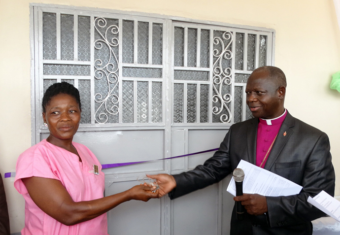 Sierra Leone Bishop John K. Yambasu (right) hands over keys to the new health center to the nurse-in-charge. The government, through the Moyamba District Health Management Team, will manage the center. Photo by Phileas Jusu, UMNS.