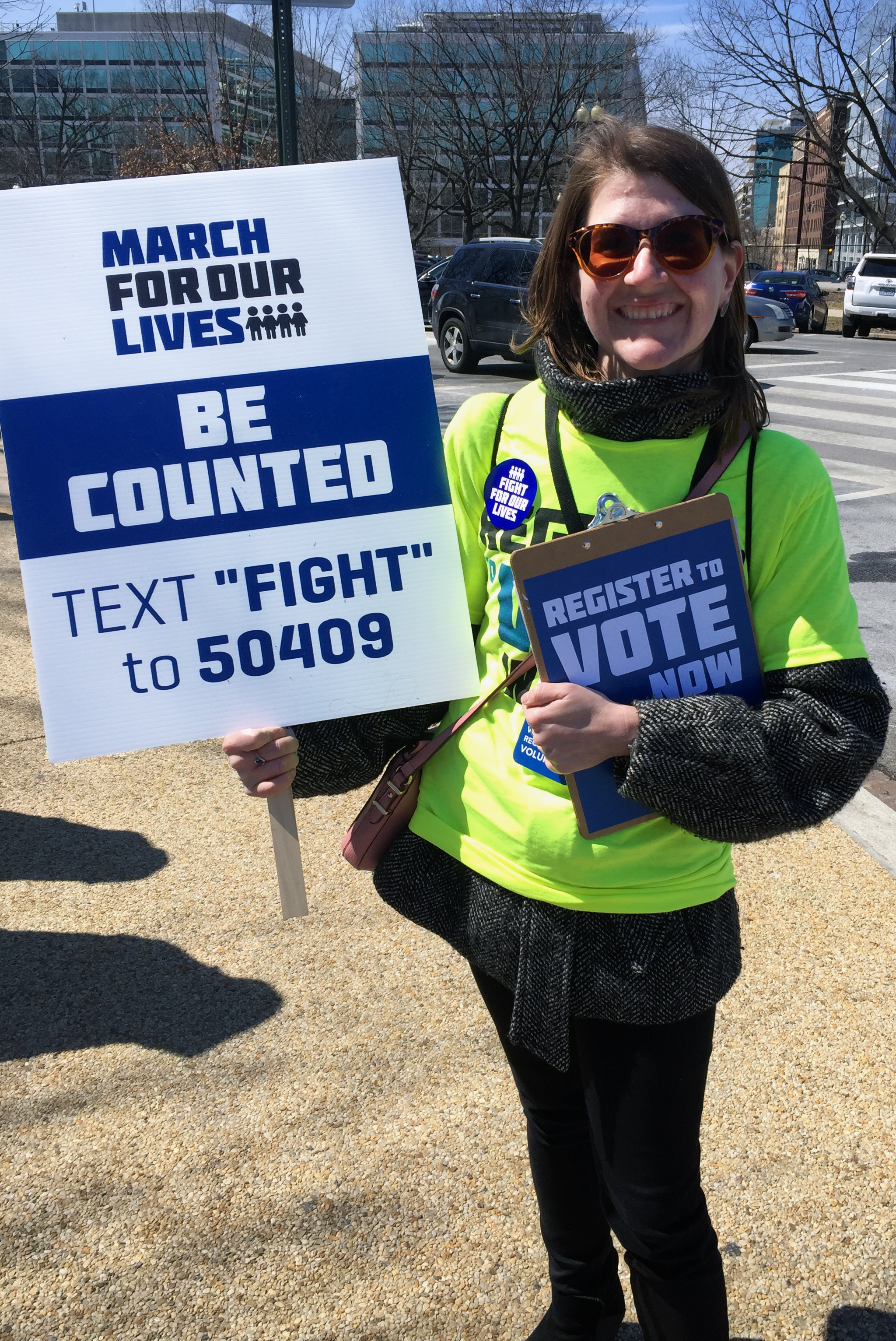 Beth Scott, a member of Foundry United Methodist Church in Washington, stands on a street corner across the street from Union Station, trying to get people to register to vote during the March for Our Lives, March 24. Photo by Erik Alsgaard.