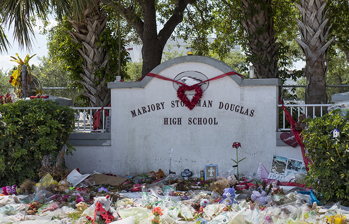 Tributes line the front of Marjory Stoneman Douglas High School for the 17 people slain on Feb. 14. Photo by Kathy L. Gilbert, UMNS.