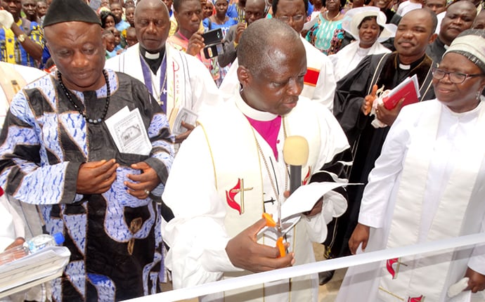 Bishop John K. Yambasu (center) cuts a ribbon to officially open Grace United Methodist Church in Kailahun, Sierra Leone. The new sanctuary is the first United Methodist church in the Kailahun District. Photo by Phileas Jusu, UMNS.