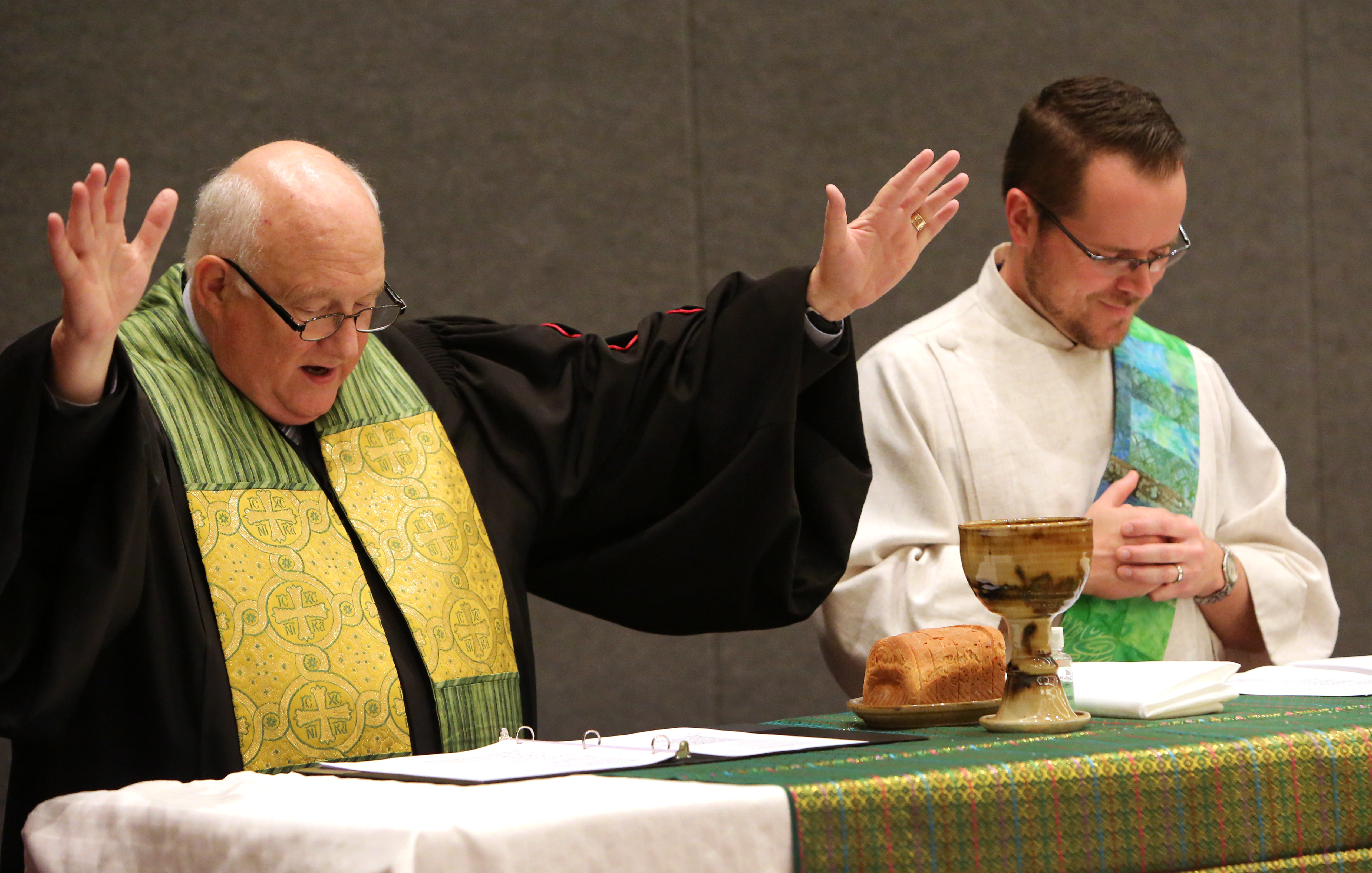 Bishop Mike Lowry and Deacon Jackson Henry preside over the May 20 communion service at the 2016 United Methodist General Conference in Portland, Ore. Photo by Kathleen Barry, UMNS