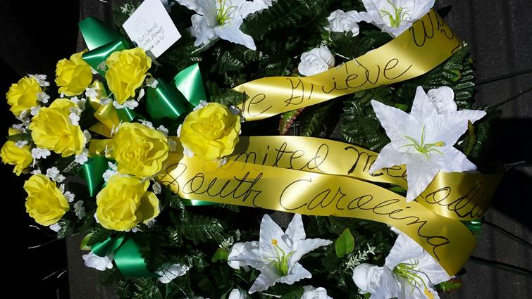 A wreath offering sympathy from The United Methodist Church was placed at the police barricade at Emanuel African Methodist Episcopal Church, where nine people were killed during Wednesday night prayer and Bible study. Photo courtesy of Billy Robinson