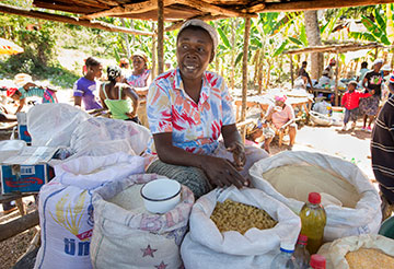 Sylviane Jean Baptist, 42, sells food from her market stall in Mizak, Haiti. She is one of the first clients of the microcredit program at Haiti Artisans for Peace International.