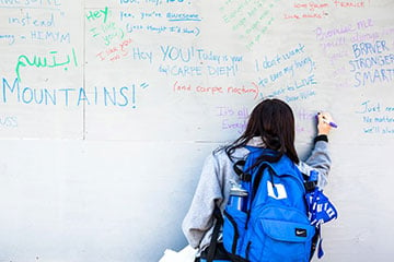 The wall holds notes that include Bible verses, Dr. Seuss quotes, Aerosmith lyrics and even drawings. Photo by John Rash.