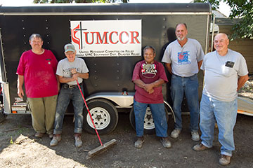 A United Methodist Volunteers in Mission Team from the Indiana Annual (regional) Conference helped homeowner Edward Ortiz (center) gut the interior of his Minot, N.D., home and clean up after flooding in June 2011. A UMNS file photo by Mike DuBose.