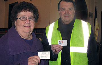 The Rev. Wilma Bone (left), then pastor of Henryville (Ind.) United Methodist Church, and Indiana Area Bishop Michael Coyner display their emergency-identification cards. Bone found her card was the key to gaining entry into Henryville after a March 2, 2012, tornado destroyed much of the town. A UMNS file photo.