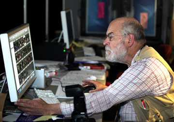 Photographer John C. Goodwin edits photos in the newsroom of the 2012 General Conference of the United Methodist Church at the Tampa (Fla.) Convention Center.  A UMNS photo by Kathleen Barry.