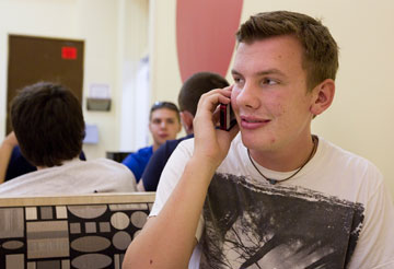 Freshman Andy Wegg keeps in touch with friends and family via smartphone at the University of Indianapolis. A UMNS photo by Mike DuBose.