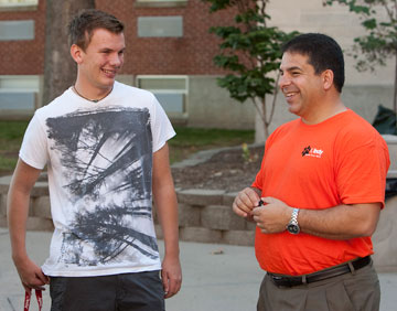 University of Indianapolis freshman Andy Wegg shares a laugh with school president Robert Manuel during the school's Freshman Move-In Day.