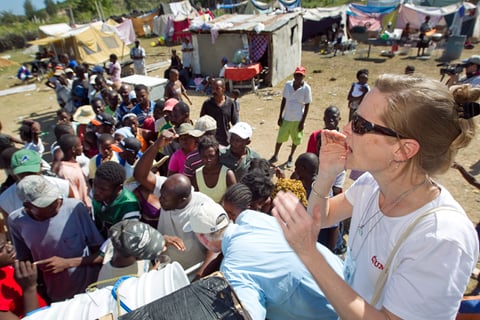 Melissa Crutchfield of the United Methodist Committee on Relief helps distribute water-treatment supplies to people living in a makeshift camp in Gresier, Haiti, in January 2010. UMNS file photos by Mike DuBose.