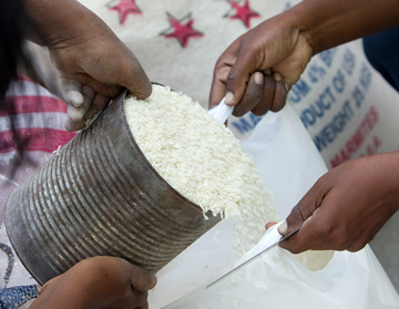 Young volunteers from the Methodist Church in Haiti measure rice for humanitarian relief in Port-au-Prince, Haiti, in January 2010.