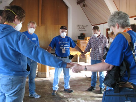 Volunteers gather in prayer inside the sanctuary of Faith United Methodist Church in Minot, N.D., following the flooding of 2011.  UMNS photos by Doreen Gosmire.