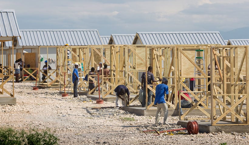 Construction workers erect homes at Camp Corail, outside Port-au-Prince. Housing, both temporary and permanent, remains a key issue as Haiti rebuilds.