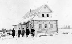 Workers stand in front of the Methodist chapel and parsonage in Haitolovo,  Russia. A UMNS photo courtesy of  the United Methodist Commission  on Archives and History.