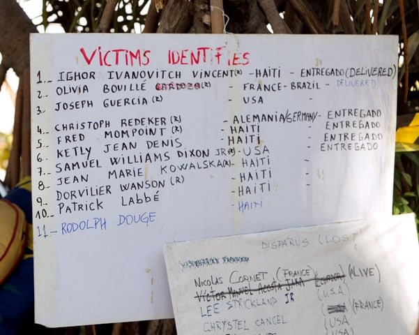 Hand-lettered signs list those killed or trapped at the Hotel Montana. A UMNS photo by Mike DuBose.