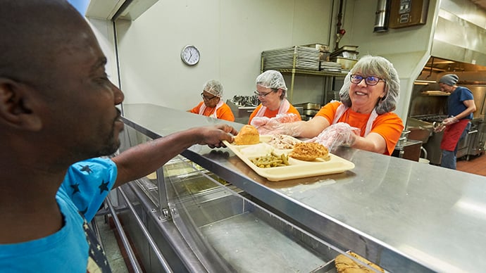 Members of United Methodist Women serve lunch to hungry people at the Community Kitchen on May 17, 2018, in Columbus, Ohio. The women were observing the Ubuntu Day of Service on the eve of the organization's Assembly 2018. Photo by Paul Jeffrey for United Methodist Women.