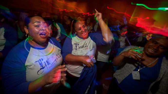 Women wearing shirts from the Limitless Teens program for young United Methodist Women celebrate their gathering's motto 